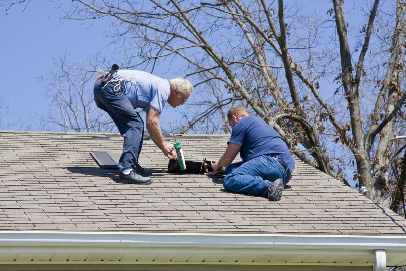 Roof repair team working on shingles
