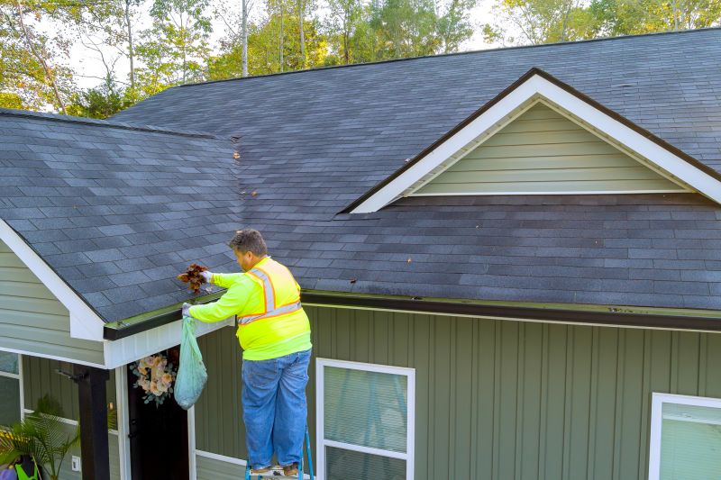Roofers cleaning up after repairs