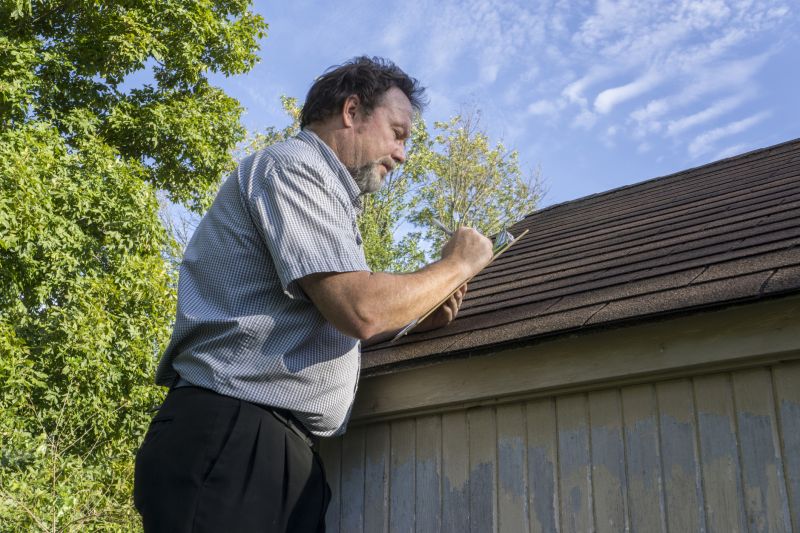 Roofing professional inspecting a roof